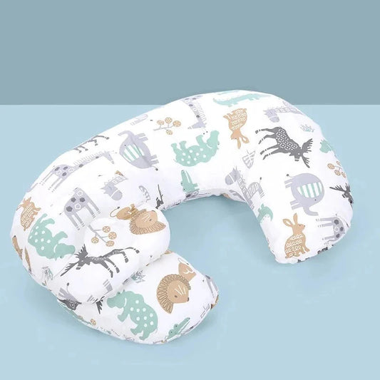 Coussin d'allaitement en fer à cheval, housse blanche à motif animaux, posé sur un fond bleu