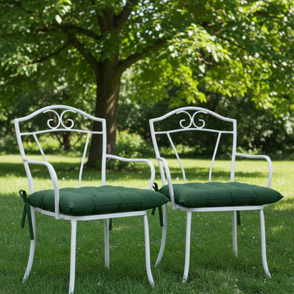 Coussins vert forêt sur des chaises de jardin en fer forgé blanc
