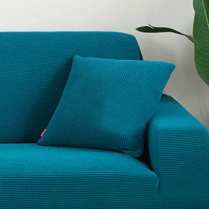 Coloris bleu canard de la housse de coussin en maille texturée