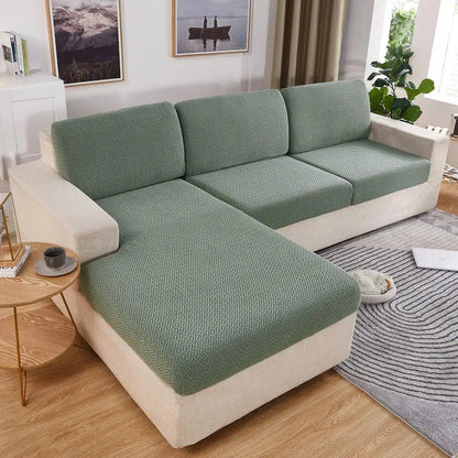 Housses vertes sur les coussins d'assise d'un canapé d'angle